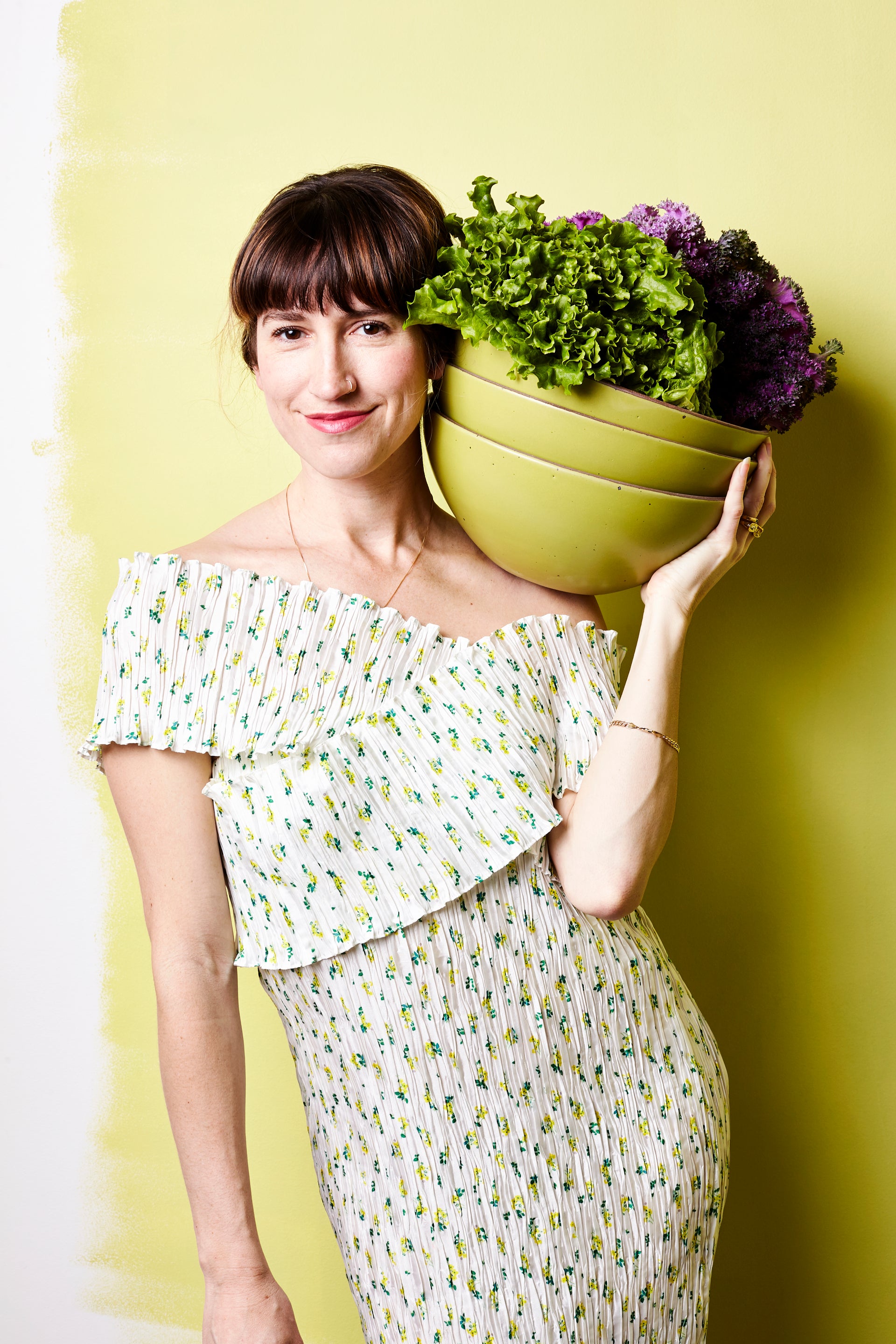 Connie holds a stack of mixing bowls in Celery