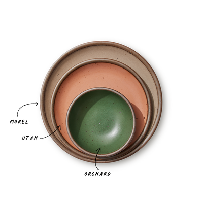 A stack of 3 plates in Dinner, Side, and Cake sizes in a warm pale brown, peach, and green colors.