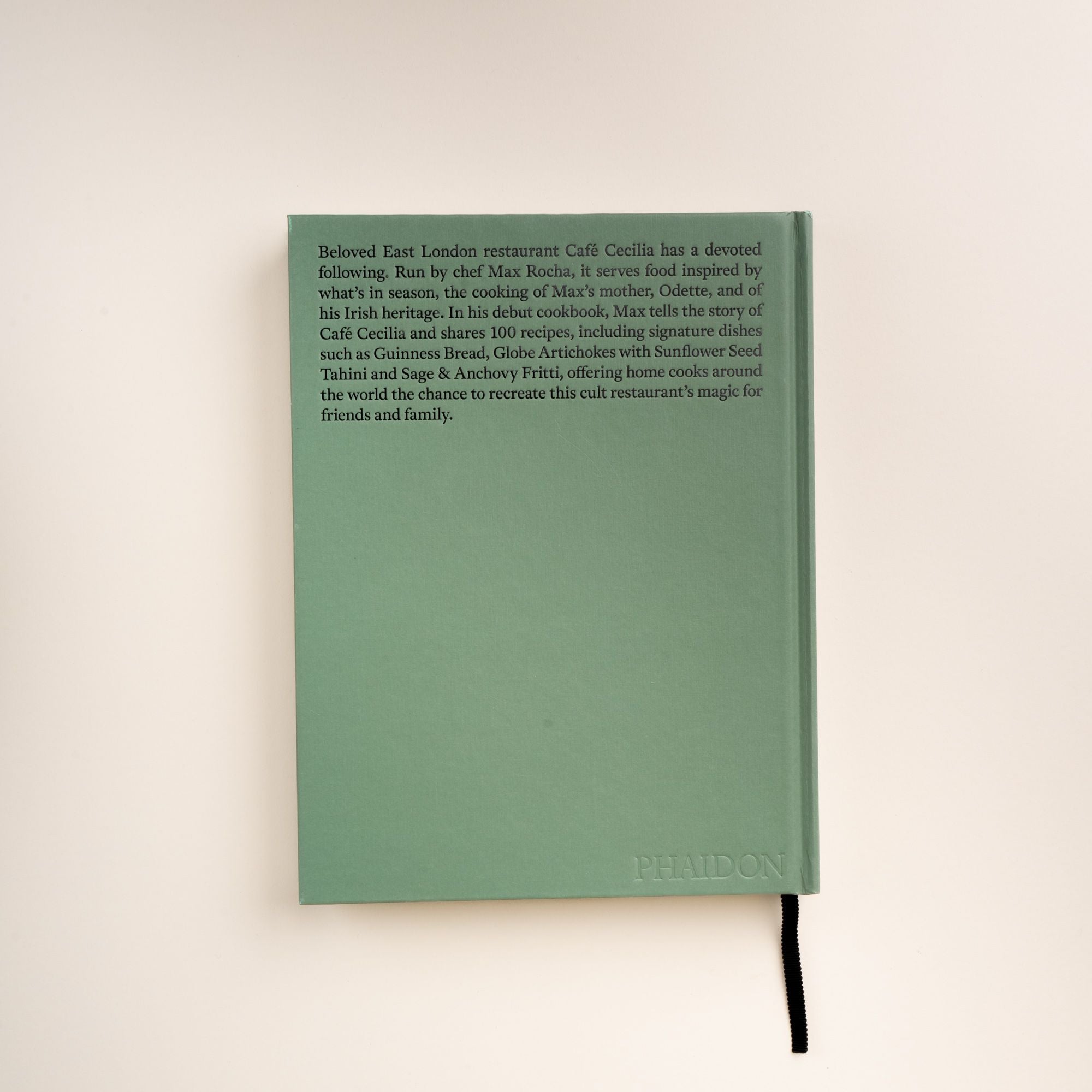 Back cover of Cafe Cecilia Cookbook by Max Rocha with text about the restaurant, recipes, and embossed Phaidon logo.