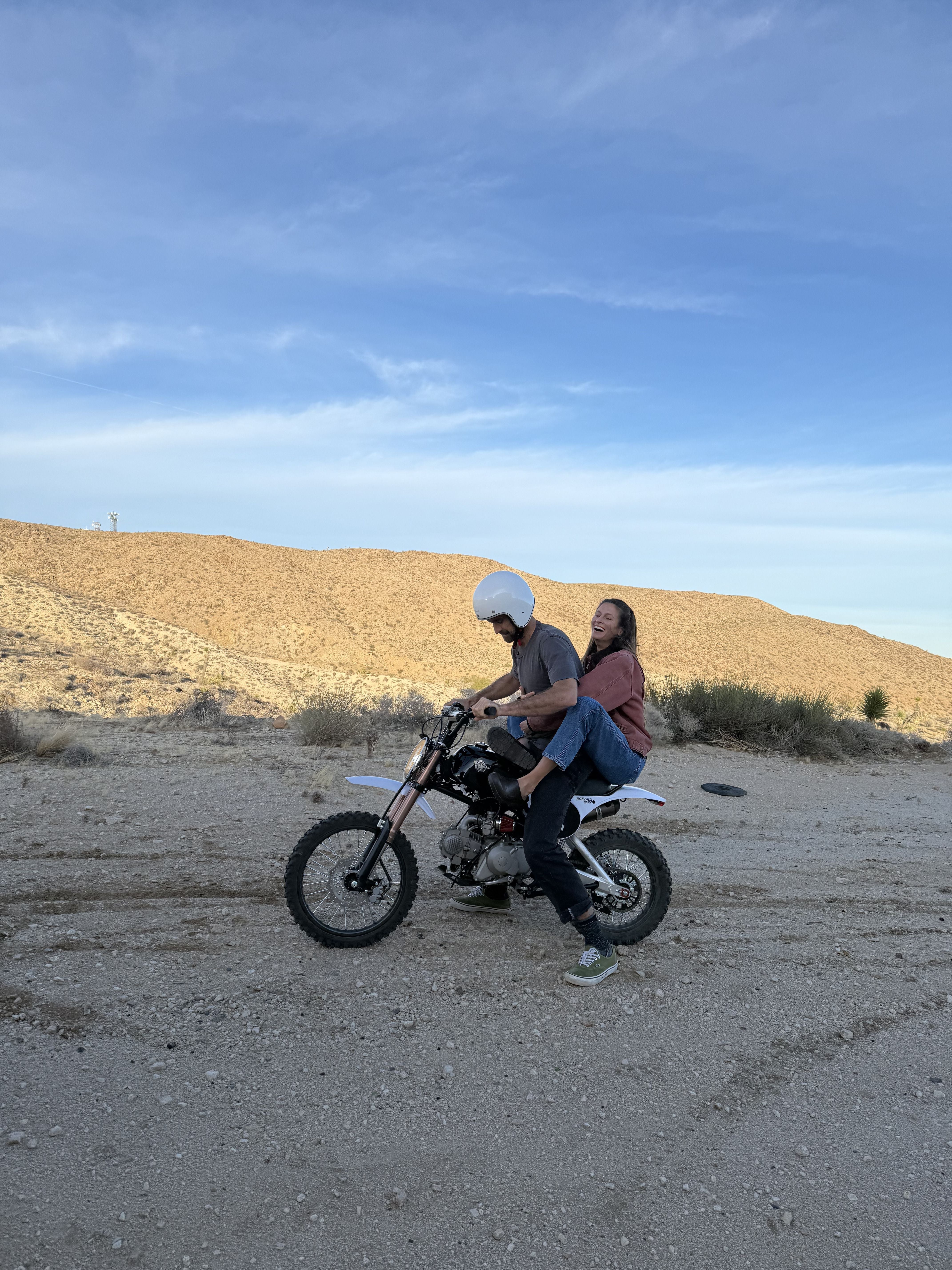 Two people ride on a Bucadero in the California desert