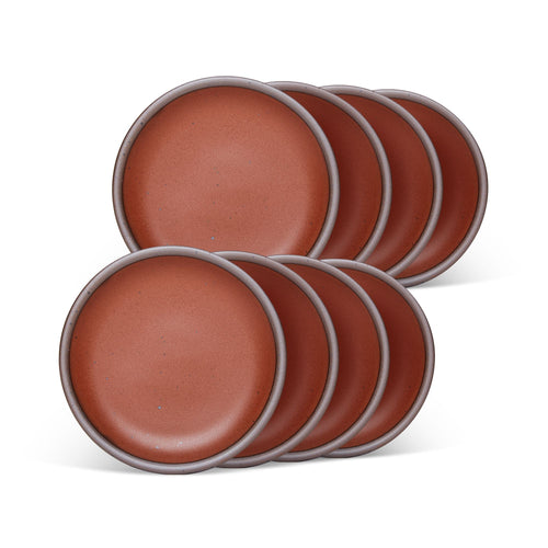 8 dessert sized ceramic plates in a cool burnt terracotta color featuring iron speckles and an unglazed rim.