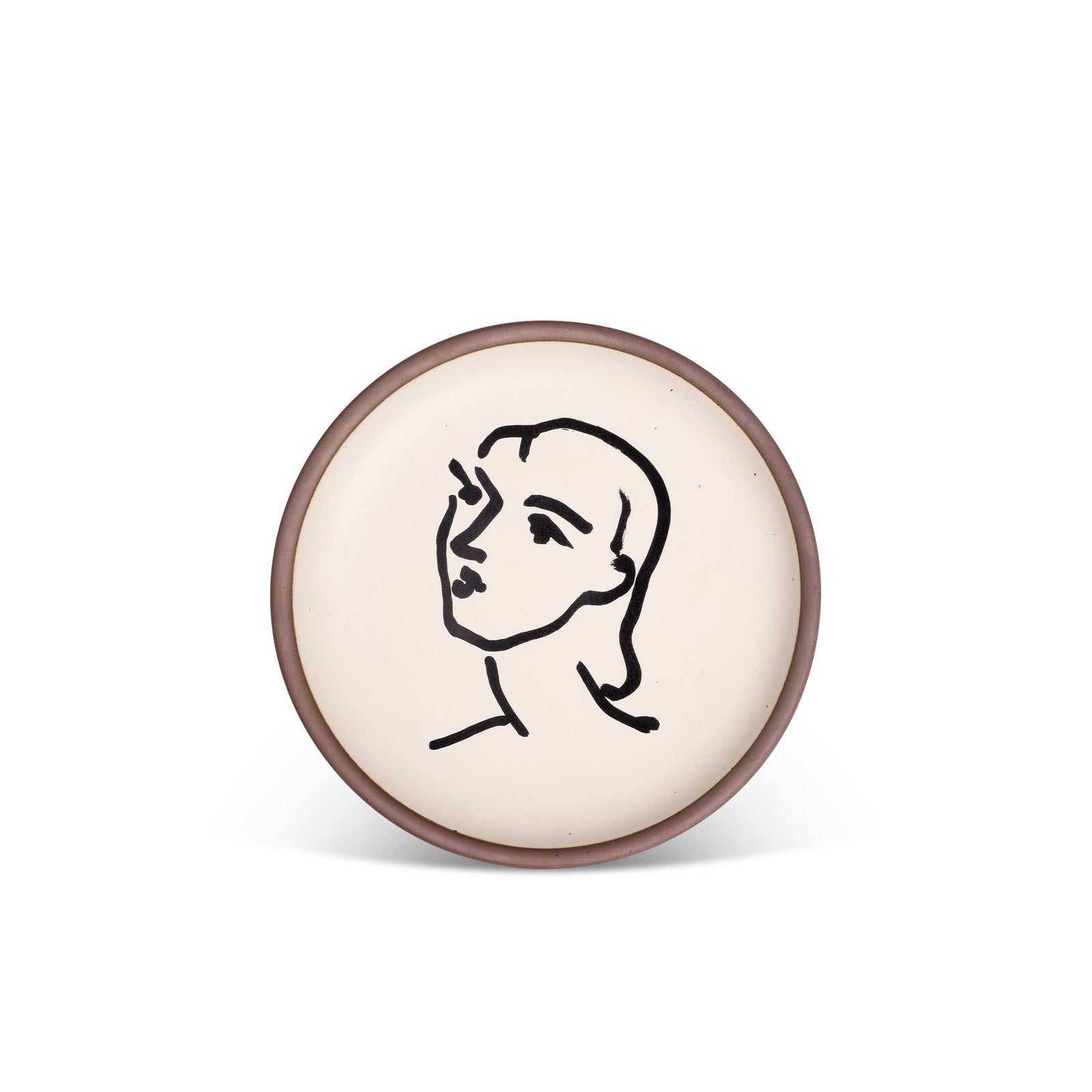 Ceramic plate with a minimalist black line drawing of a face on a cream background, bordered by a subtle earthy-toned rim.