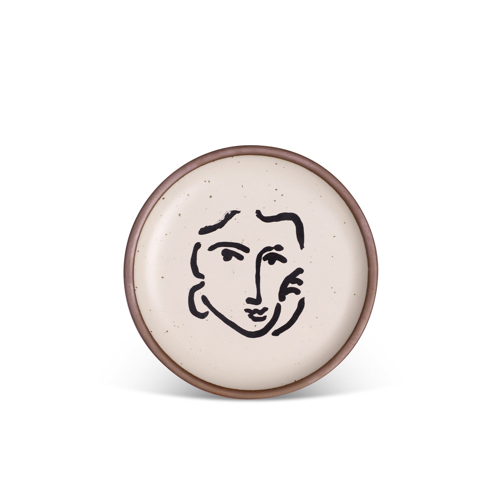 Round ceramic plate with a minimalist black line drawing of a face on a speckled, cream-colored glaze, edged with a brown rim.