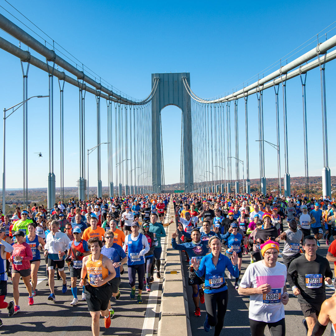 Marathon runners running across the Brooklyn Bridge