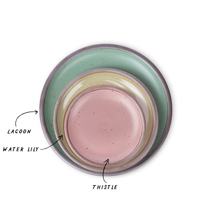 Three nested ceramic plates with different colors, green, reflective green, and dusty pink with labels on a white background