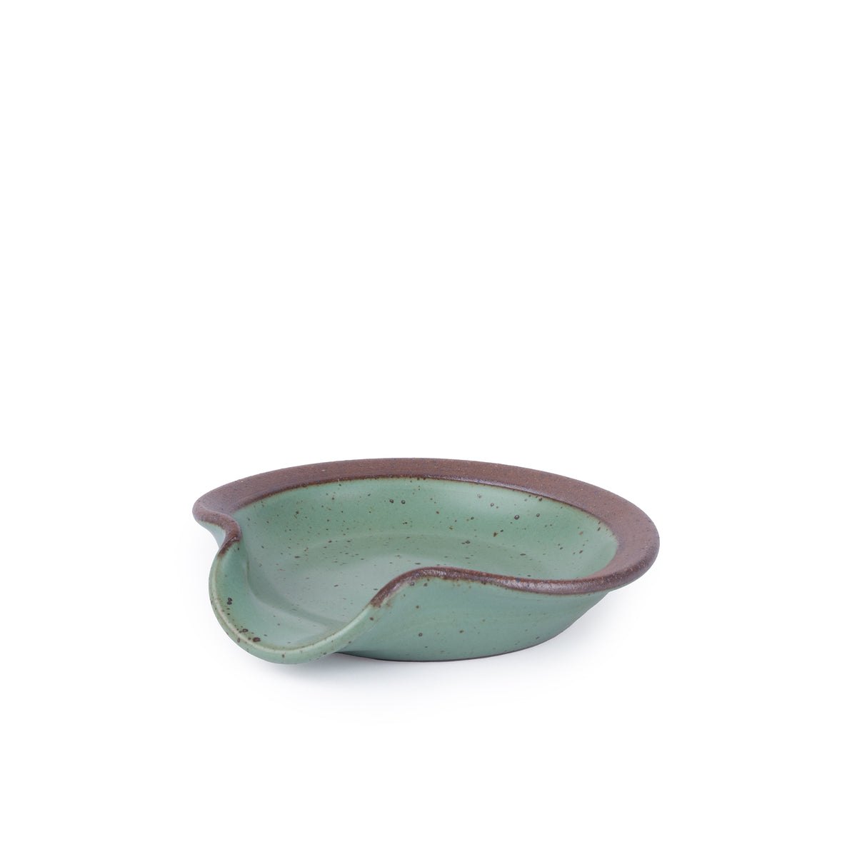 A circular ceramic spoon rest in a green color featuring iron speckles and unglazed ridge rim