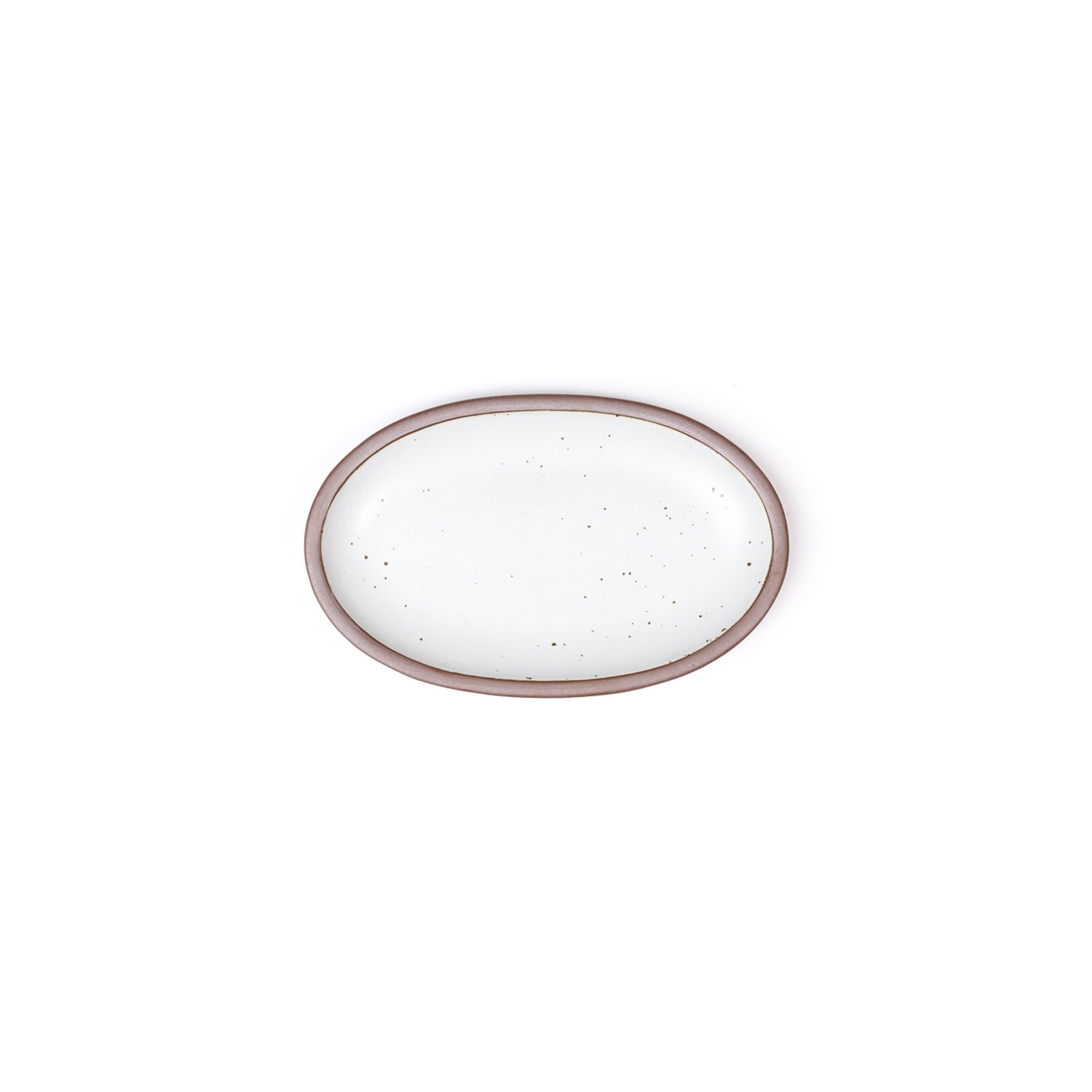 A small oval ceramic platter in a cool white color featuring iron speckles and an unglazed rim