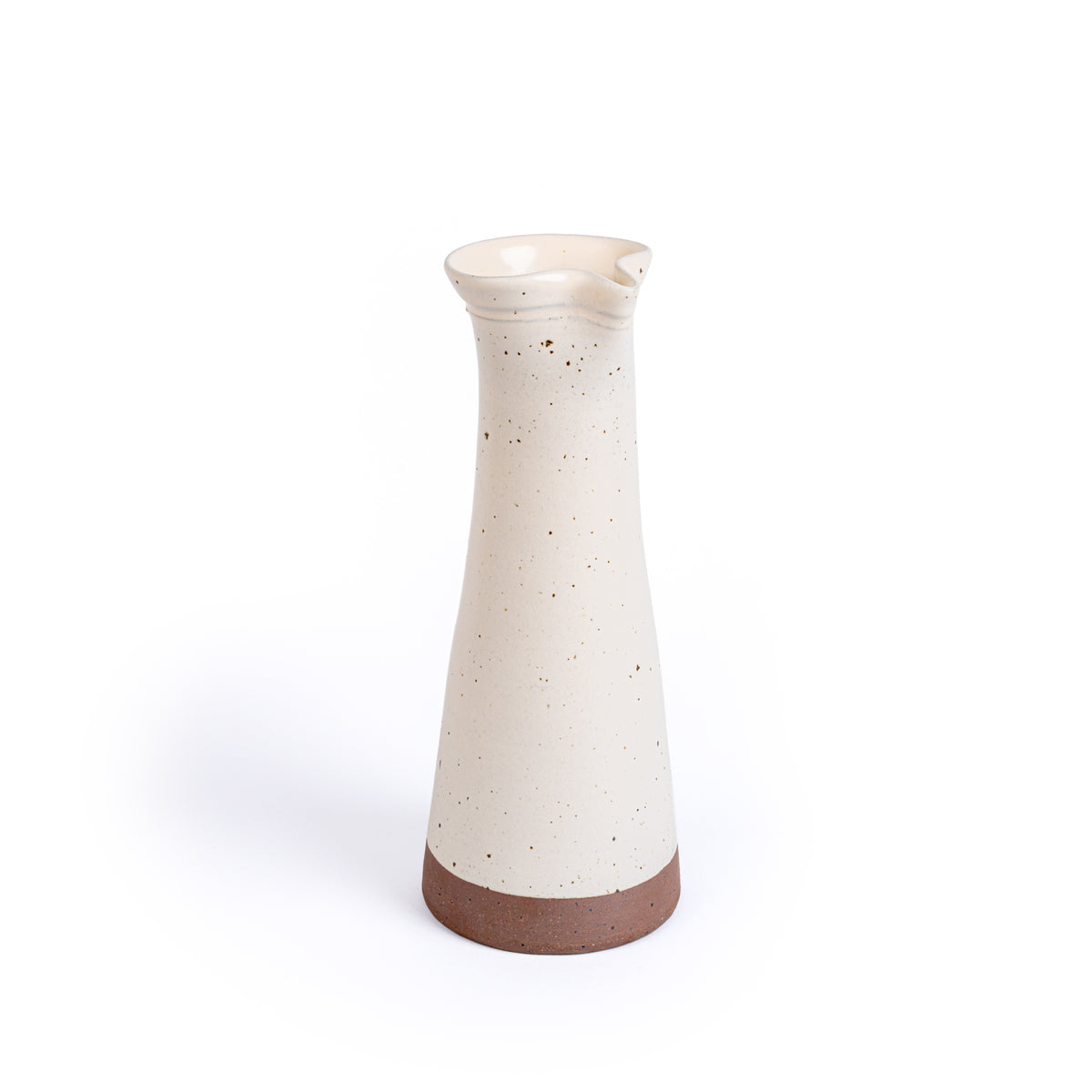 Tall ceramic carafe in an off-white color with iron speckles and an unglazed base.