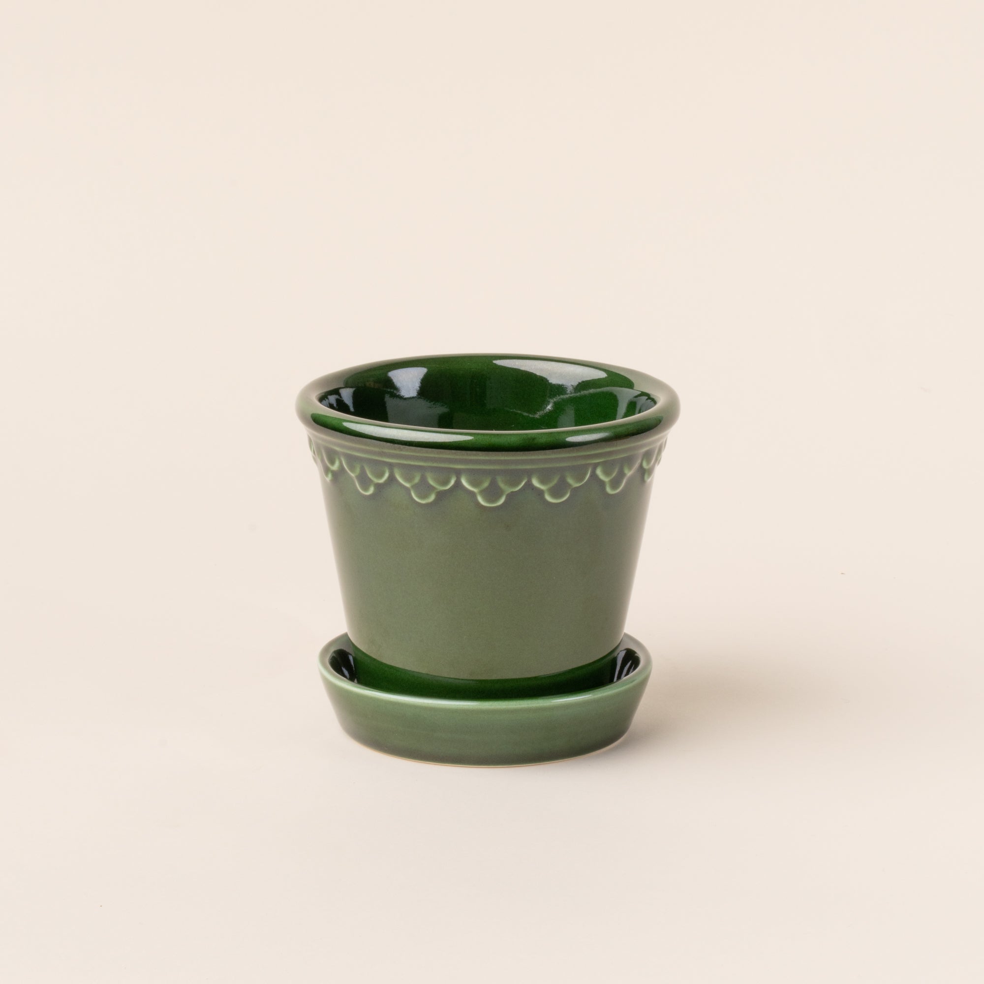 Small glossy green ceramic pot.