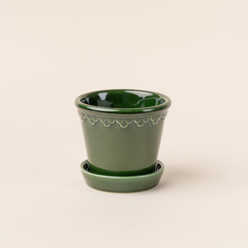 Small glossy green ceramic pot.