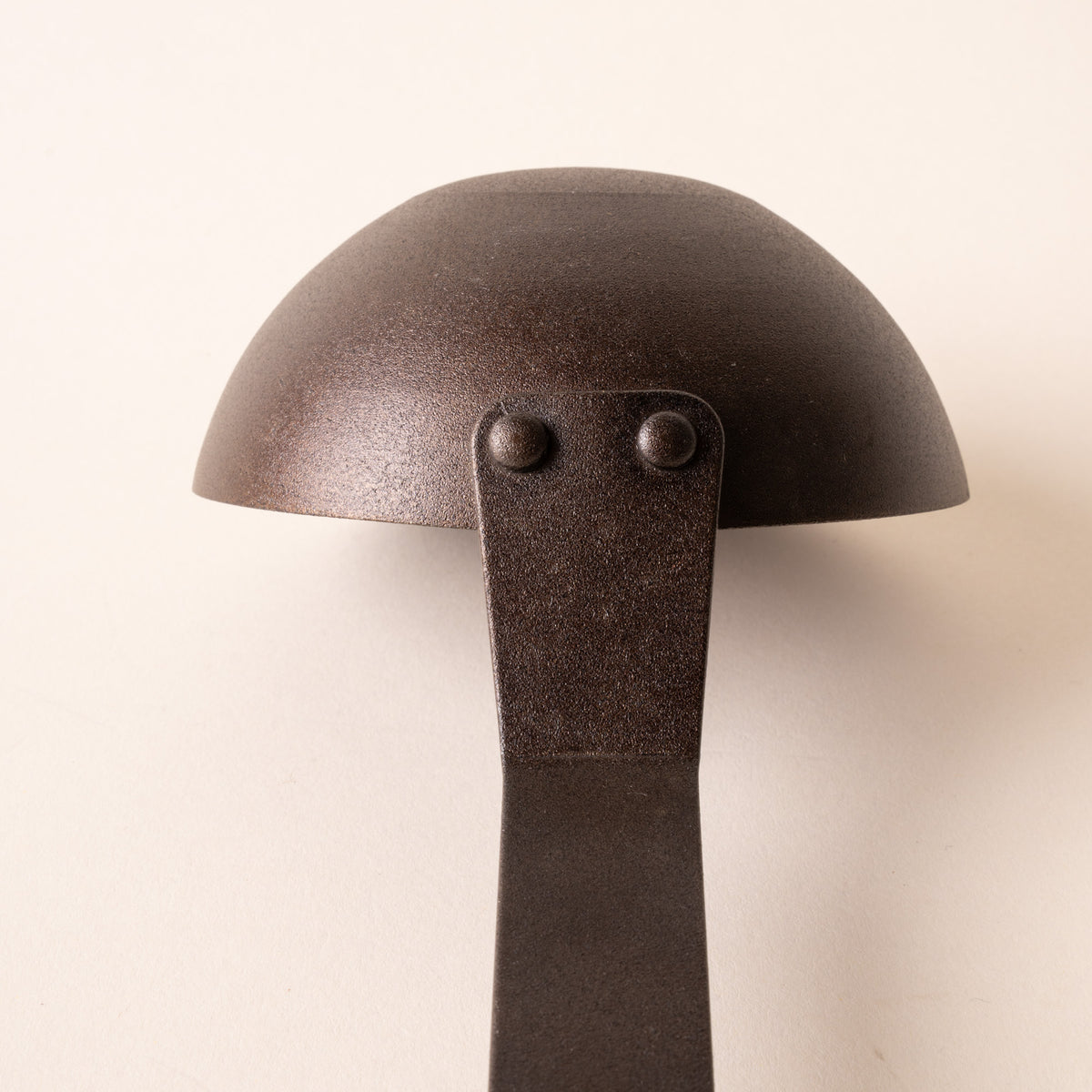 Close up of the cup of a cast iron ladle