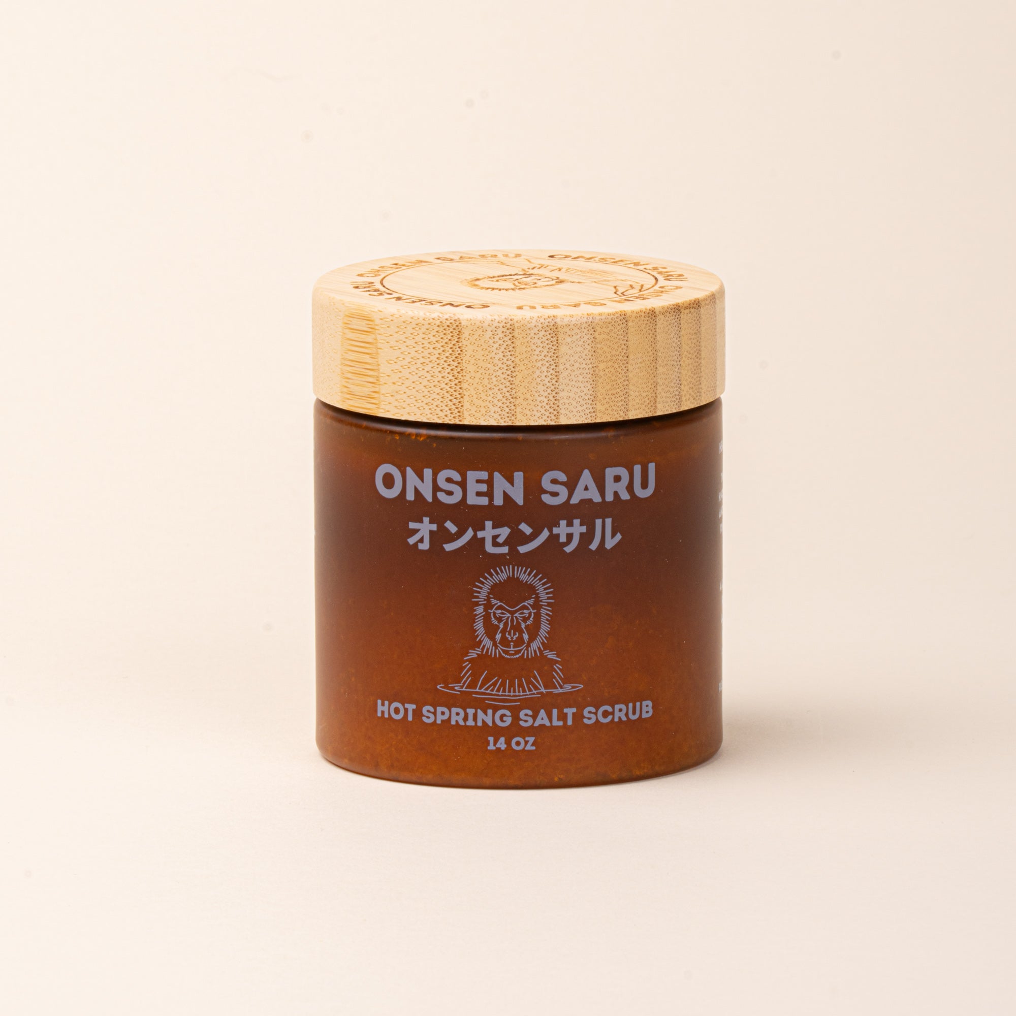 Onsen Saru Hot Spring Salt Scrub in an amber jar with a bamboo lid.
