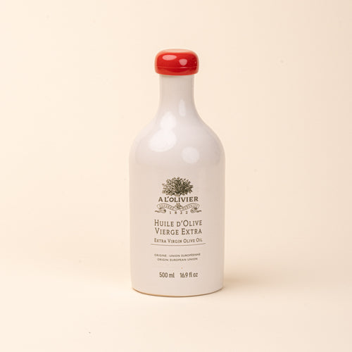 White ceramic bottle of A L'Olivier extra virgin olive oil with a red cap and gold lettering, 500 ml.