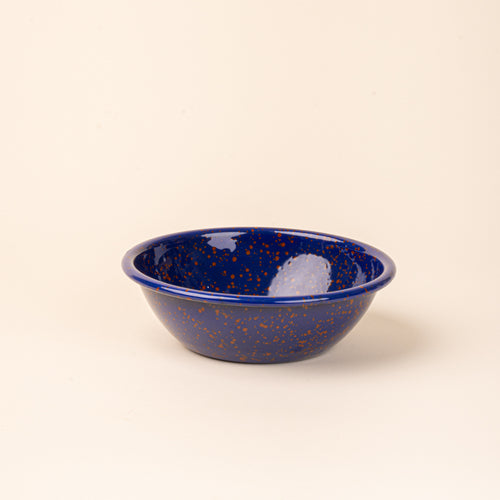 A large enamel bowl in midnight blue color with red splatter pattern.