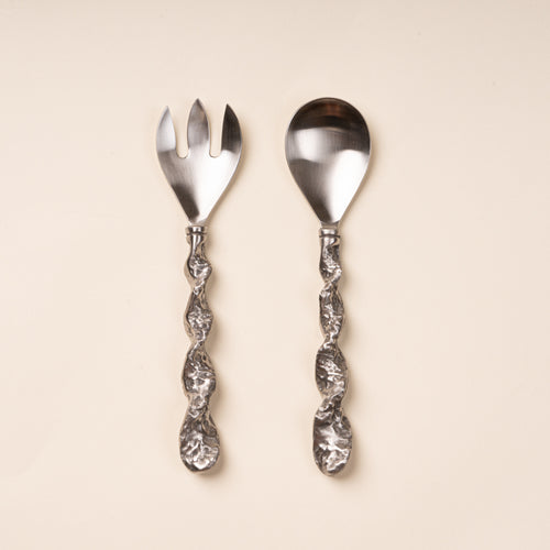 Stainless steel salad serving fork and spoon with textured twisted handles.