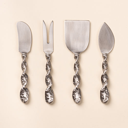 Four stainless steel cheese utensils with textured twisted handles, including knives, a fork, and a cheese server.