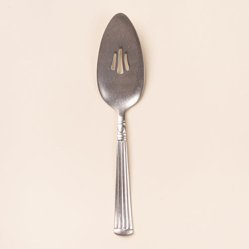 Vintage-inspired silver pie server with a slotted blade and fluted handle.