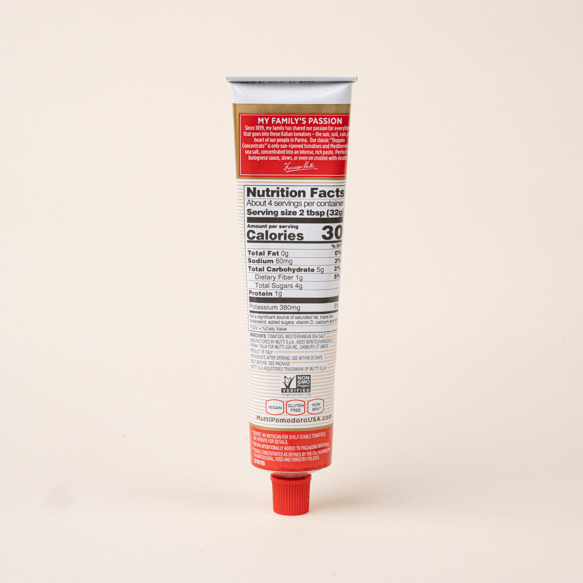 Back view of a tube of Mutti double concentrated tomato paste showing nutrition facts, ingredients, and product information.