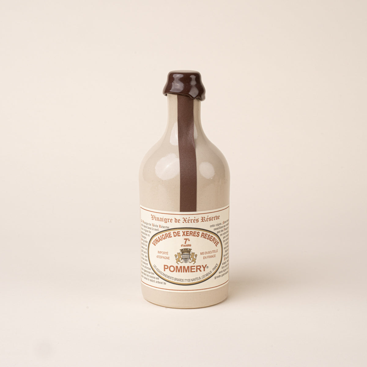 White ceramic bottle of Pommery sherry vinegar with a dark brown wax seal, matching ribbon, and printed label.
