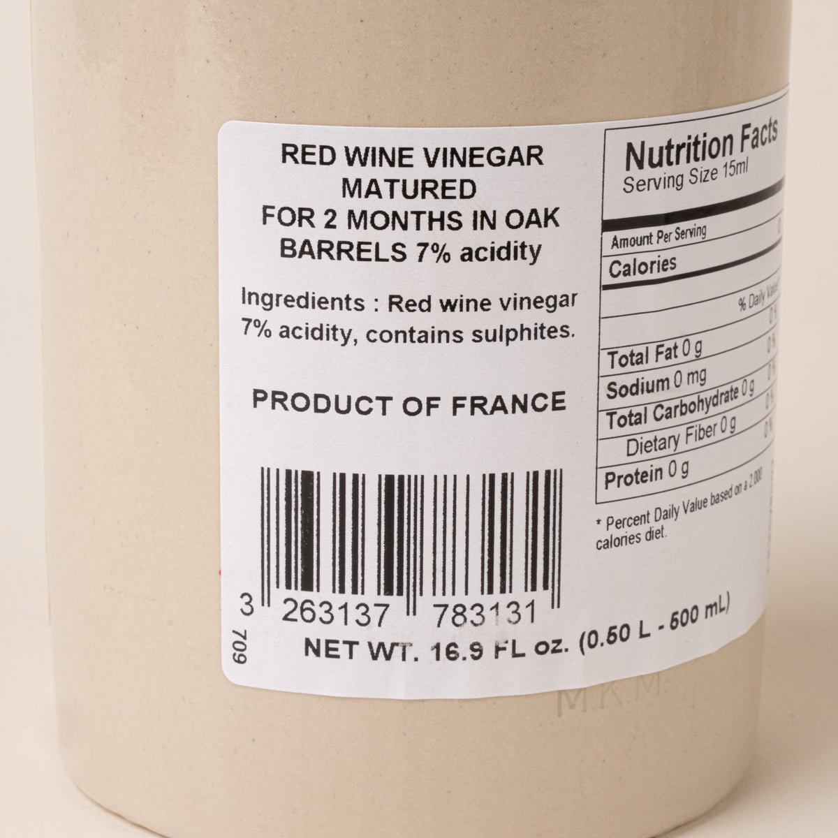 Close-up of the back label of Pommery red wine vinegar showing ingredients, nutrition facts, product origin, and barcode.