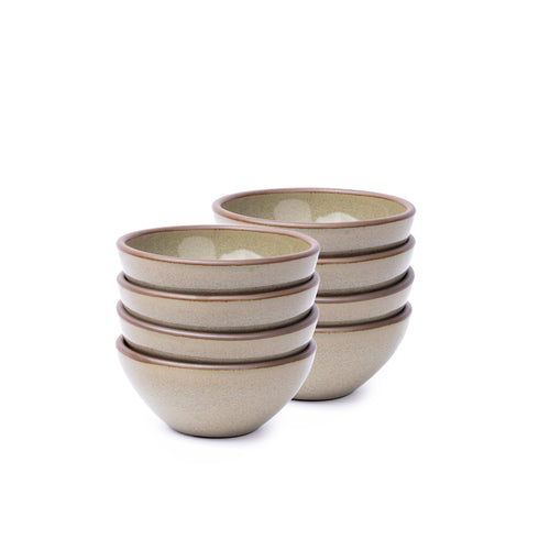 A stack of 8 small dessert sized rounded ceramic bowls in a reflective dappled grey-green color featuring an unglazed rim