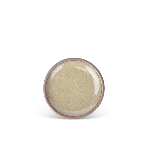 A dessert sized ceramic plate in a reflective dappled grey-green color featuring an unglazed rim