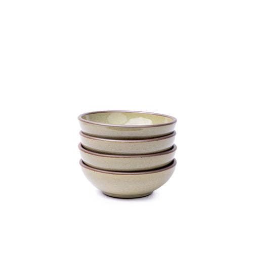 A stack of 4 small shallow ceramic bowls in a reflective dappled grey-green color featuring an unglazed rim