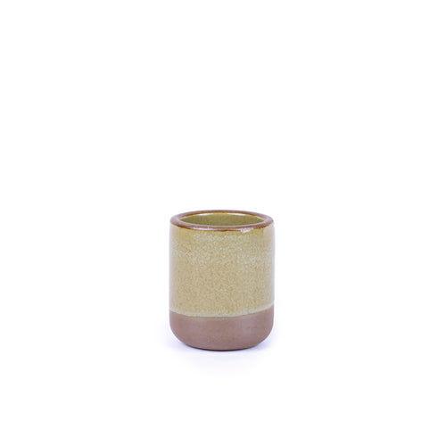 A small, short ceramic mug cup in a reflective dappled grey-green color featuring an unglazed rim and bottom base.