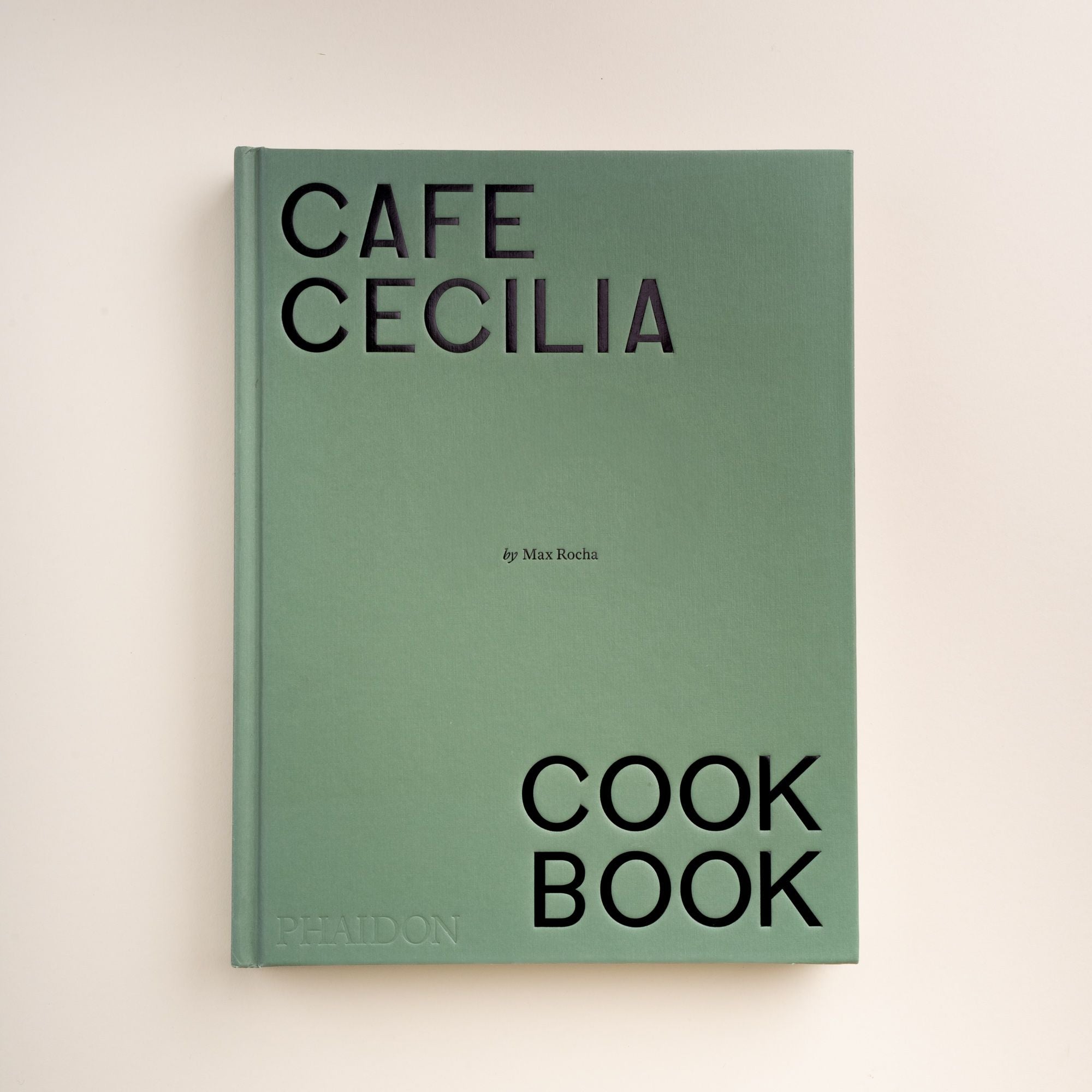 Front cover of Cafe Cecilia Cookbook by Max Rocha, published by Phaidon, in a minimalist green design with bold black lettering.