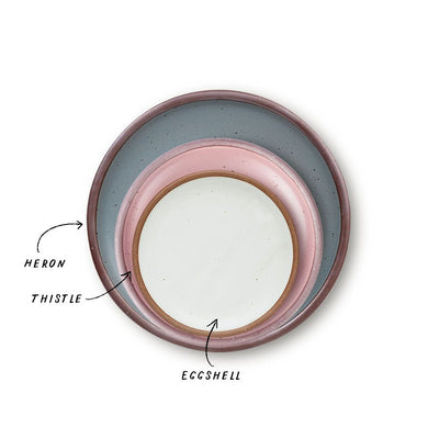 A stack of 3 plates in Dinner, Side, and Cake sizes in a dusty mauve pink, blue-grey, and cool white colors.