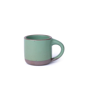 A ceramic mug with a compact form and study handle in a viridian green glaze with a matte finish.