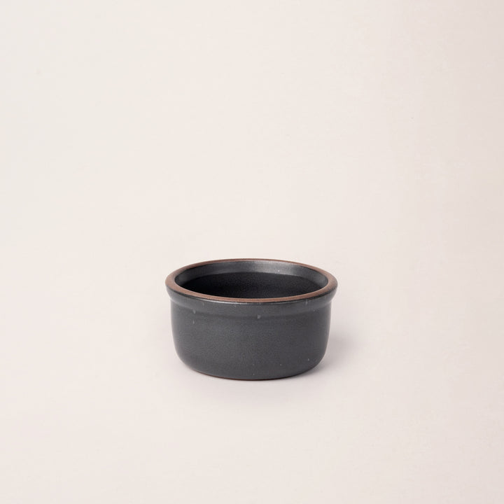 Small ceramic ramekin in a graphite black  color with an unglazed rim
