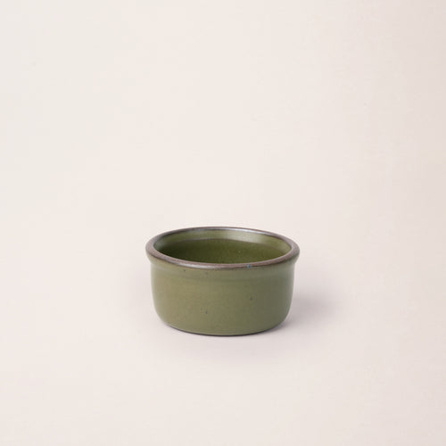 Small ceramic ramekin in an olive green color with an unglazed rim