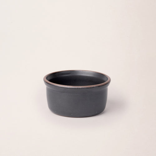 Medium ceramic ramekin in a graphite black  color with an unglazed rim