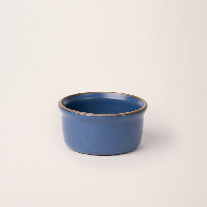 Medium ceramic ramekin in a cool blue color with an unglazed rim
