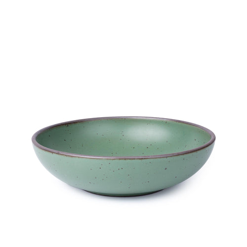 A large shallow ceramic bowl for serving at the table in a viridian green glaze with a matte finish.