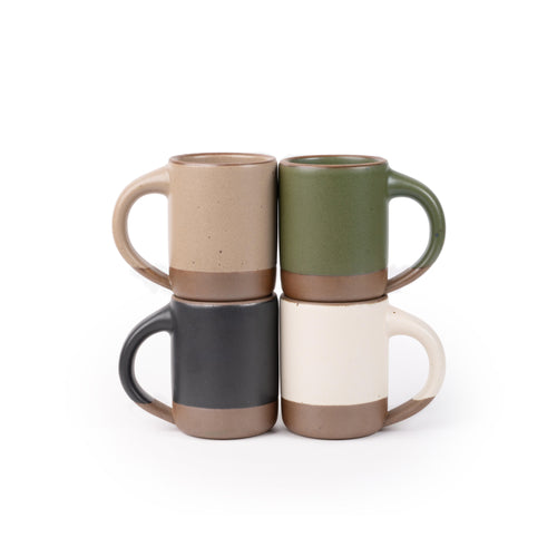 Four medium sized ceramic mugs with handles in an olive green, warm off-white, graphite black, and warm pale brown colors featuring iron speckles and unglazed rim