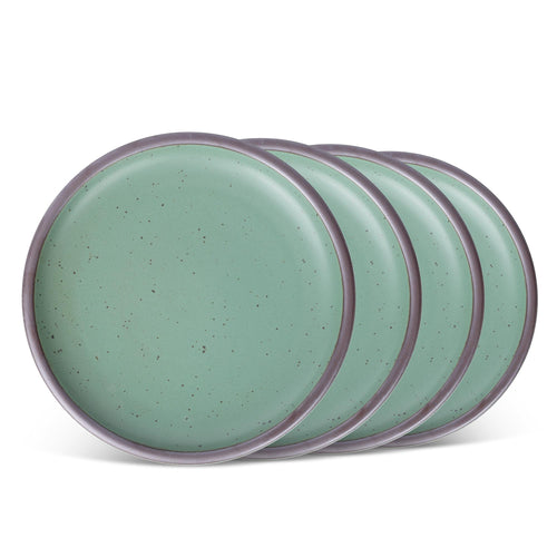 Four ceramic plates with a wide surface and low rims in a viridian green glaze with a matte finish.