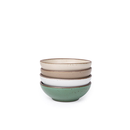 Four shallow ceramic bowls for cereal or yogurt in a viridian green, warm brown, warm white and cool white glazes.