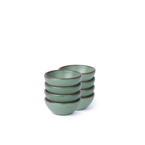 Eight small ceramic bowls for salt, mise en place, or jewelry in a viridian green glaze with a matte finish.