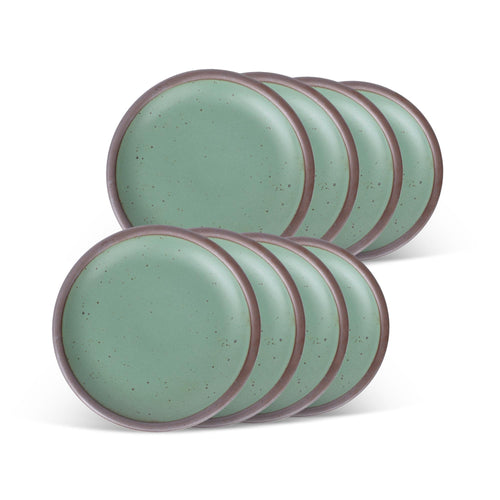 Eight ceramic plates with flat surfaces and raised edges in a viridian green glaze with a matte finish.