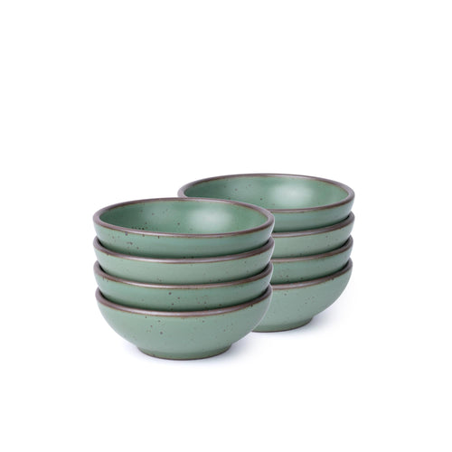 Eight shallow ceramic bowls for cereal or yogurt in a viridian green glaze with a matte finish.