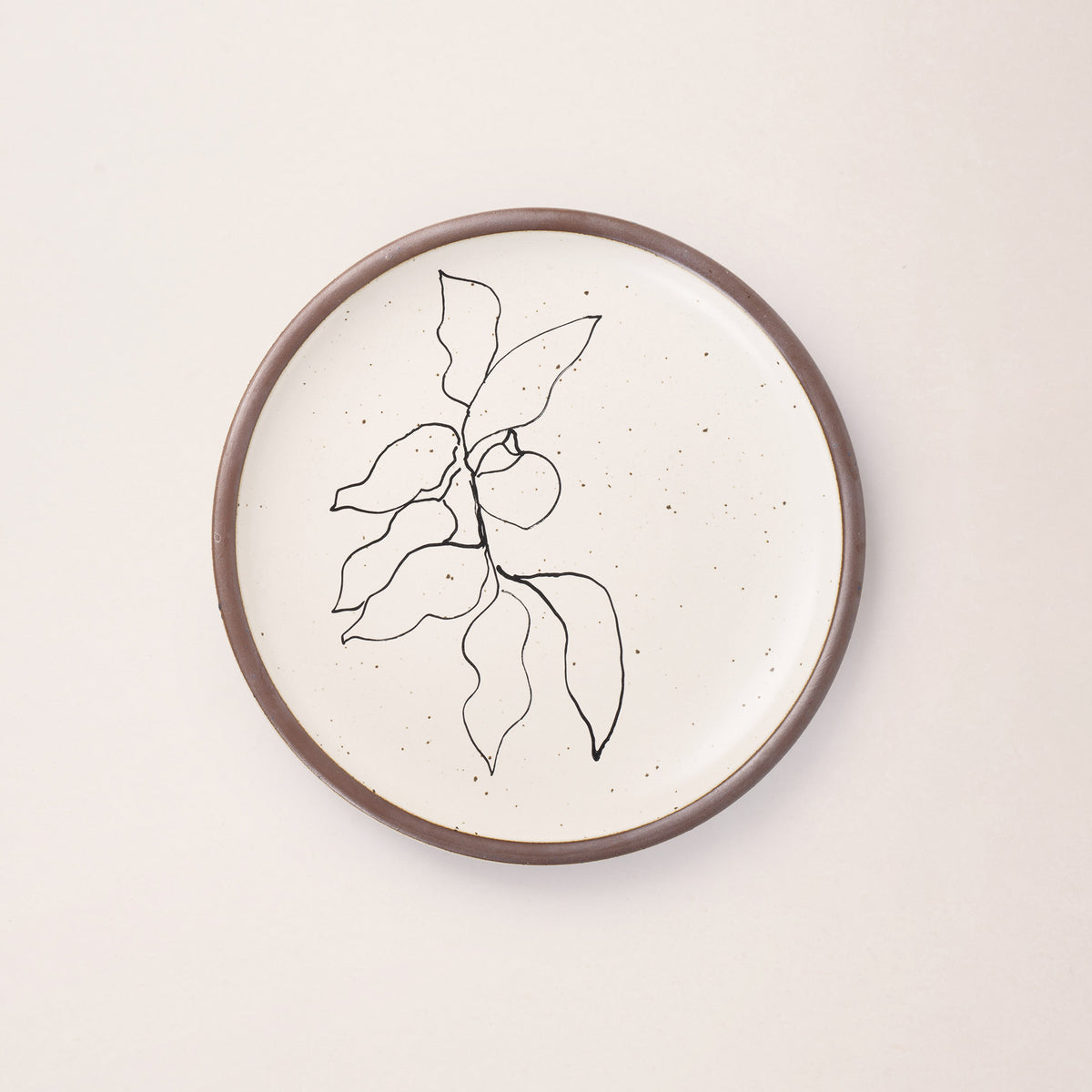 A warm off-white ceramic dinner plate featuring a black Verve illustration by Henri Matisse.