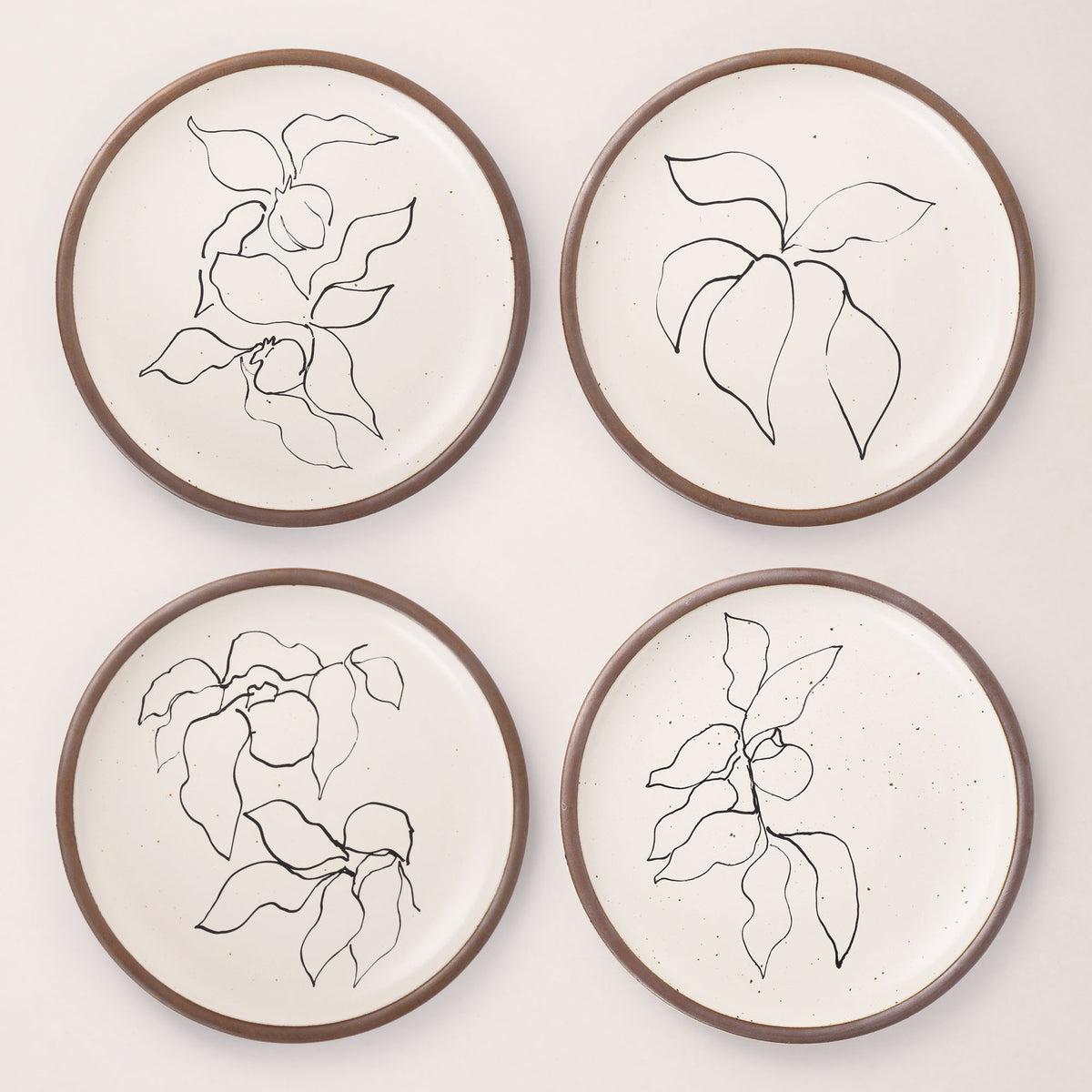 Four round ceramic dinner plates featuring Verve illustrations by Henri Matisse.