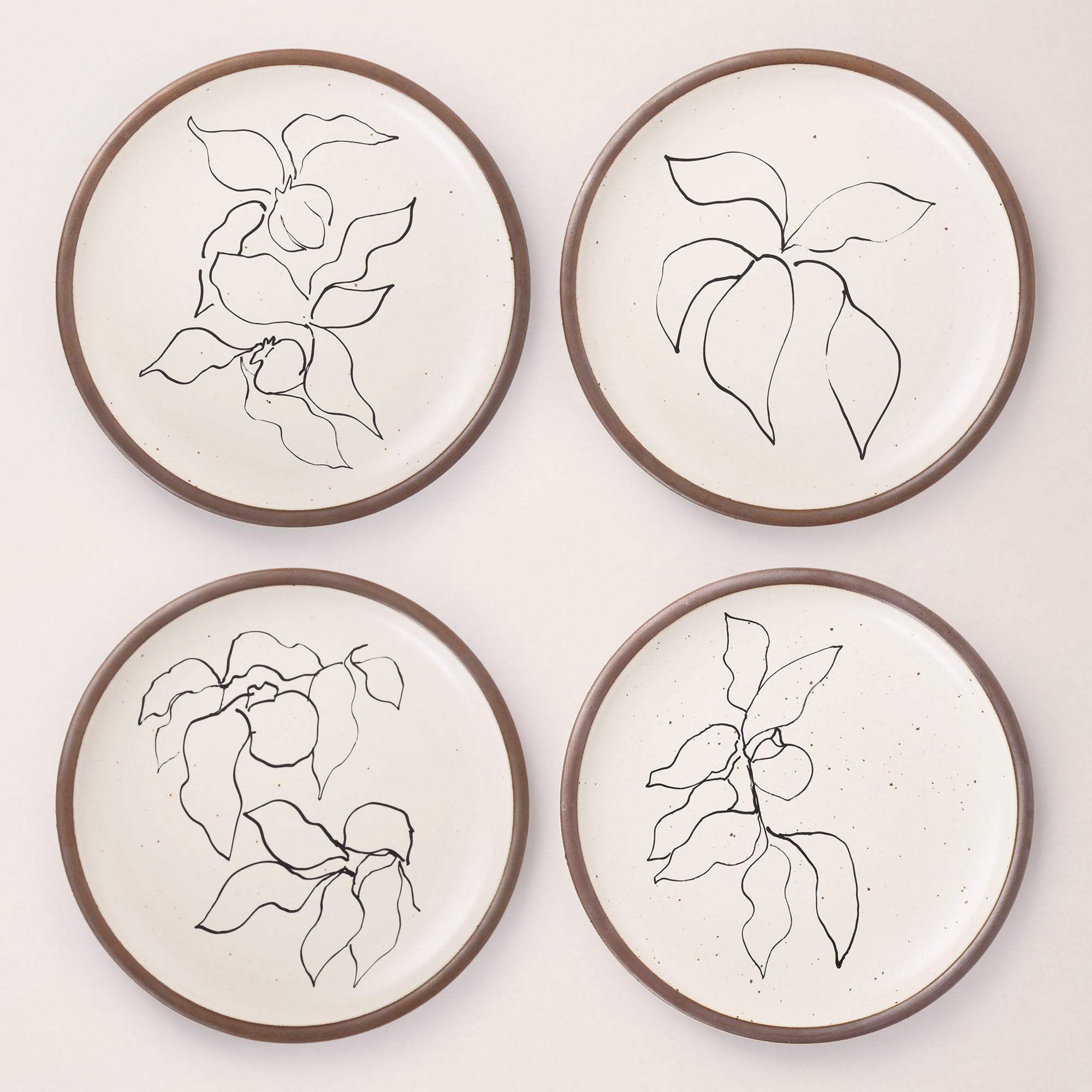 Four round ceramic dinner plates featuring Verve illustrations by Henri Matisse.
