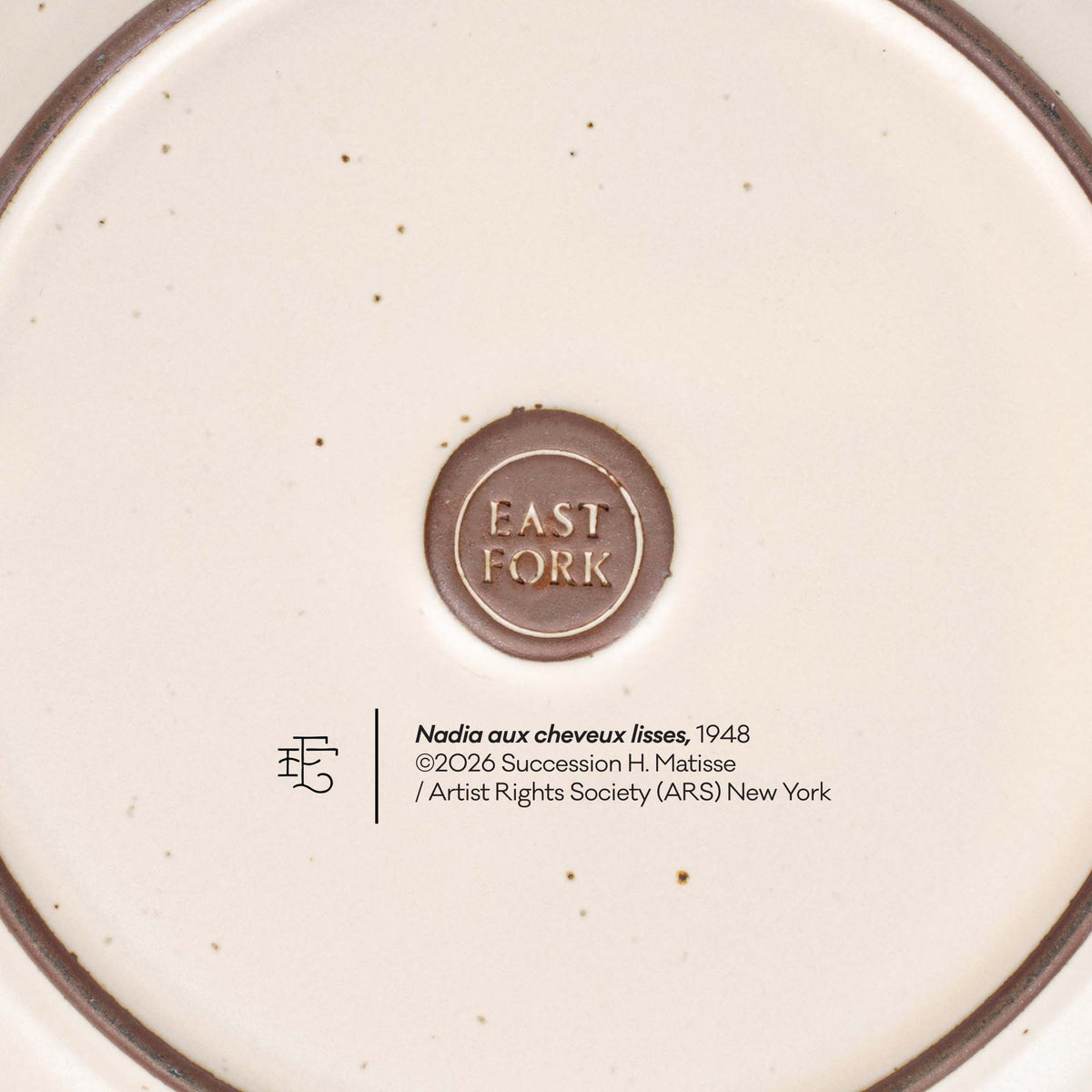 The back of a side plate with an East Fork stamp with a small decal of information about the artwork, Nadia aux cheveux lisses, by Henri Matisse.