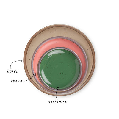 A stack of 3 plates in Dinner, Side, and Cake sizes in a pale warm brown, watermelon pink, and glossy emerald green colors.