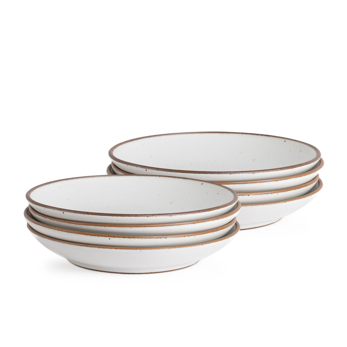A stack of six shallow ceramic bowls in a light speckled glaze with brown rims, displayed against a plain white background.