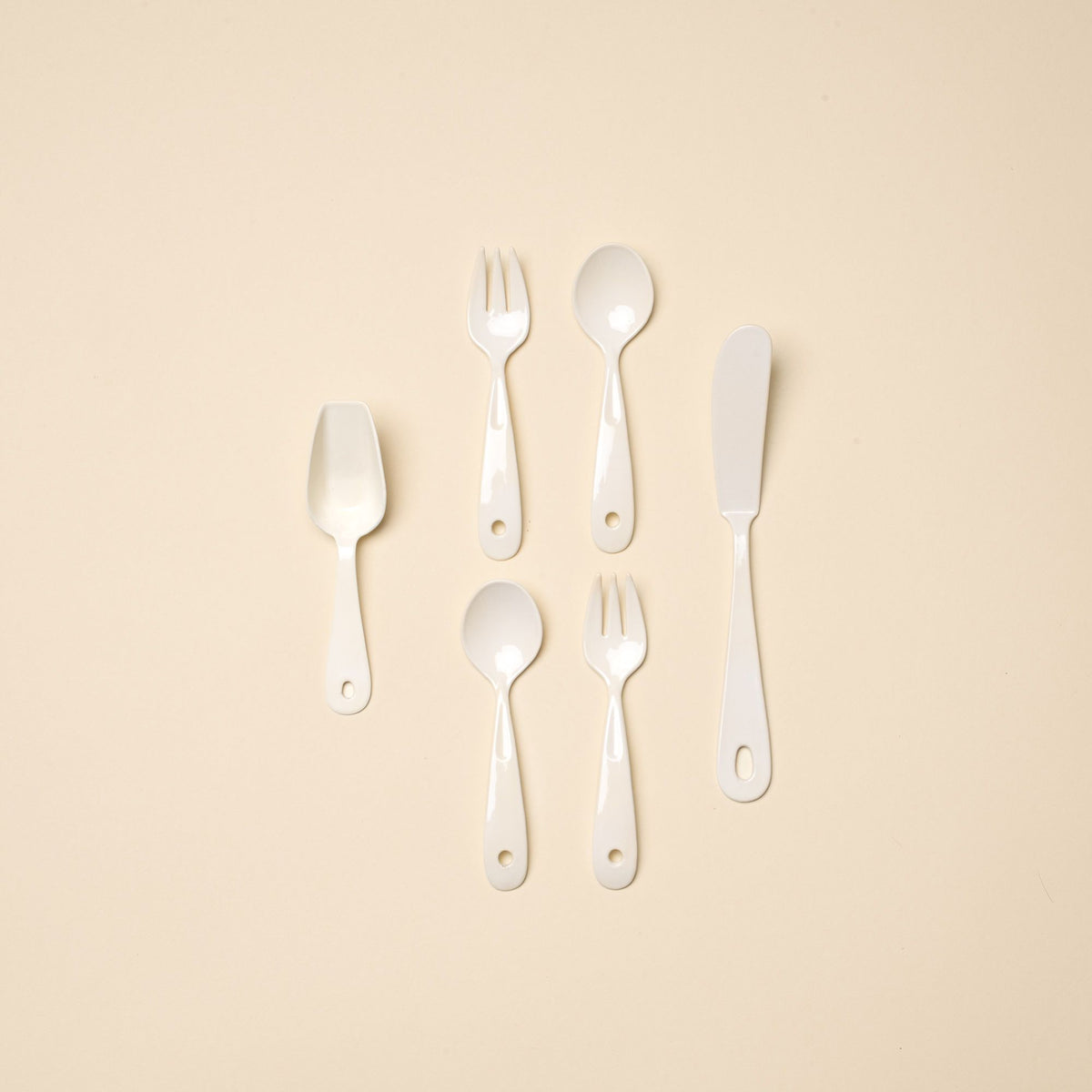 Tiny Scoop, Mini Spoon and Fork Set, and Butter Knife all lined up laying flat.