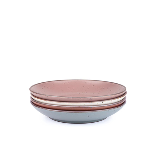 A stack of 4 large ceramic plates with a curved bowl edge in a cool terracotta, warm off-white, blue-grey and dusty mauve pink colors featuring iron speckles and an unglazed rim.